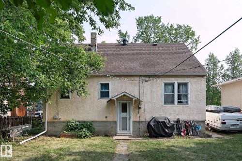 View of front of property featuring a shingled roof, a chimney, and stucco siding - 11559 80 Avenue, Edmonton, AB - Outdoor