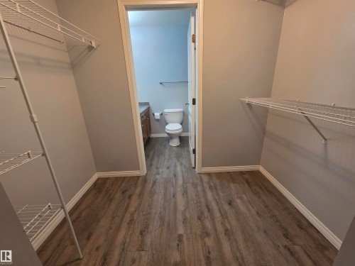 Walk in closet with dark wood finished floors - 106 4903 47 Avenue, Stony Plain, AB - Indoor With Storage