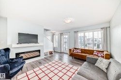 Living room featuring a glass covered fireplace and wood finished floors - 