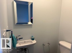 Half bath with toilet and a sink - 