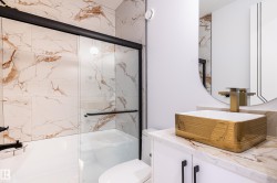 Bathroom with vanity and a marble finish shower - 