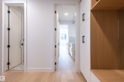 Corridor featuring light wood finished floors - 