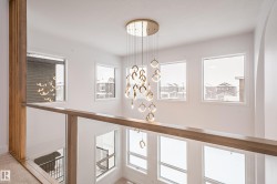Hallway with a chandelier and plenty of natural light - 