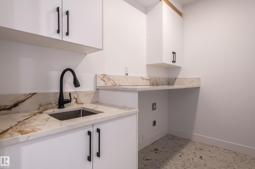 Laundry room featuring baseboards and cabinet space - 43 Eldridge Point(E), St. Albert, AB - Indoor Photo Showing Kitchen