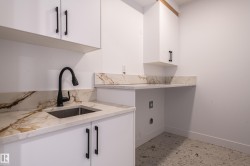 Laundry room featuring baseboards and cabinet space - 