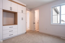 Unfurnished bedroom with light carpet and baseboards - 