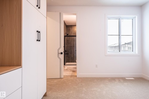 Unfurnished bedroom with connected bathroom and light carpet - 43 Eldridge Point(E), St. Albert, AB - Indoor Photo Showing Other Room