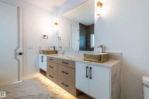 Full bathroom with marble look tiles and double vanity - 43 Eldridge Point(E), St. Albert, AB - Indoor Photo Showing Bathroom