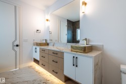 Full bathroom with marble look tiles and double vanity - 