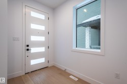 Doorway to outside featuring wood finished floors and baseboards - 