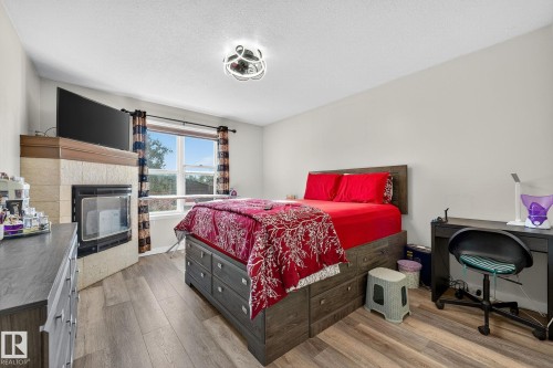 3 1920 Millwoods Road E, Edmonton, AB - Indoor Photo Showing Bedroom With Fireplace