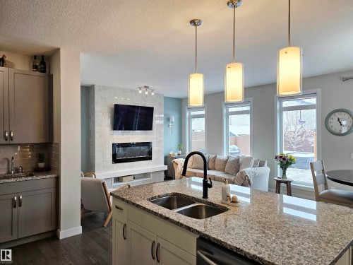 122 Joyal Way, St. Albert, AB - Indoor Photo Showing Kitchen With Fireplace With Double Sink