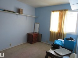 Living area featuring light carpet and baseboards - 