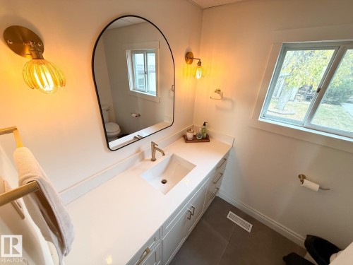 Half bathroom featuring toilet and vanity - A15 Wicks Street, Rural Leduc County, AB - Indoor Photo Showing Bathroom