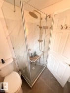 Full bath featuring a marble finish shower and toilet - 