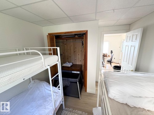 Bedroom with a drop ceiling, light wood-style floors, and a closet - A15 Wicks Street, Rural Leduc County, AB - Indoor Photo Showing Bedroom