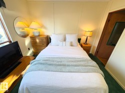 Bedroom featuring dark carpet and a decorative wall - 