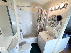 Bathroom with vanity and shower / bath combo - 