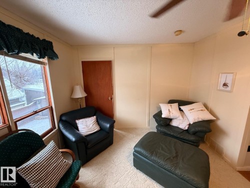 Sitting room featuring a textured ceiling and carpet flooring - A15 Wicks Street, Rural Leduc County, AB - Indoor