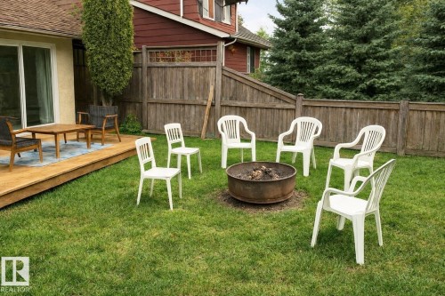 View of yard featuring a fire pit and a deck - A15 Wicks Street, Rural Leduc County, AB - Outdoor With Deck Patio Veranda