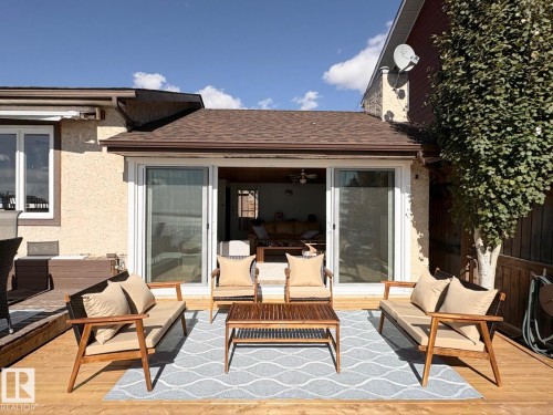 Wooden deck with an outdoor hangout area - A15 Wicks Street, Rural Leduc County, AB - Outdoor With Deck Patio Veranda With Exterior