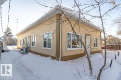 View of snowy exterior with stucco siding - 