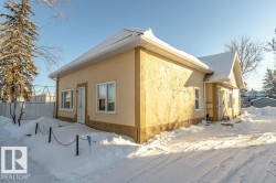 Snow covered property with stucco siding - 
