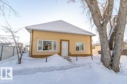 Snow covered property featuring stucco siding - 