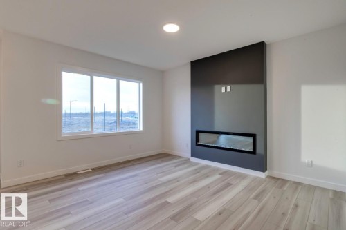 907 18 Avenue, Edmonton, AB - Indoor Photo Showing Living Room With Fireplace