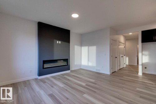 907 18 Avenue, Edmonton, AB - Indoor Photo Showing Living Room With Fireplace