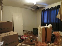 Misc room with a textured ceiling and wallpapered walls - 