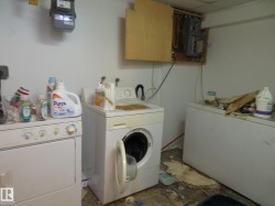 Laundry room featuring electric panel, washing machine and clothes dryer, and cabinet space - 
