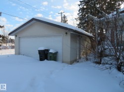 Snow covered garage featuring a garage - 
