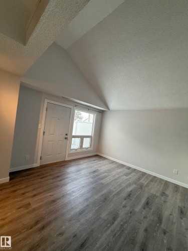 Spacious Living room and door to private deck - 23 Lancaster Terrace, Edmonton, AB - Indoor Photo Showing Other Room