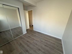 Bedroom 2 with a closet and LVP wood-style floors - 