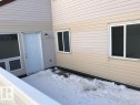 View of snow covered private deck with property entrance to living room - 23 Lancaster Terrace, Edmonton, AB  - Outdoor With Exterior 