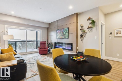 527 7463 May Common, Edmonton, AB - Indoor Photo Showing Other Room With Fireplace