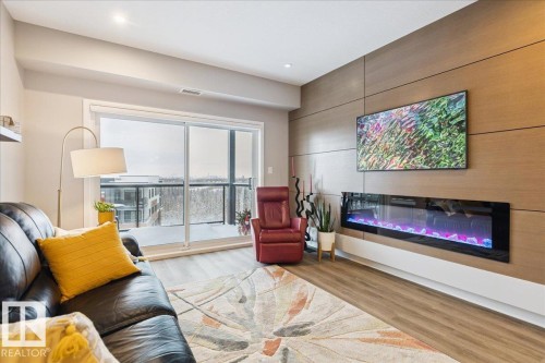 527 7463 May Common, Edmonton, AB - Indoor Photo Showing Living Room With Fireplace