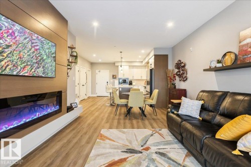 527 7463 May Common, Edmonton, AB - Indoor Photo Showing Living Room With Fireplace