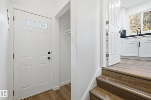 Foyer entrance with light wood-style flooring and baseboards - 13507 124 Avenue, Edmonton, AB - Indoor Photo Showing Other Room