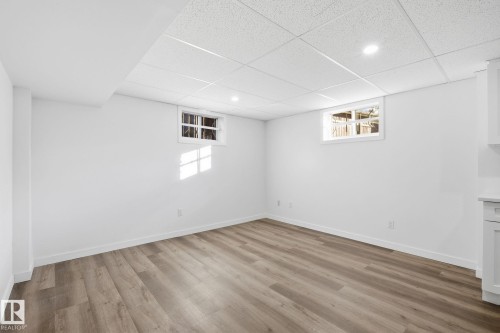 Basement with a paneled ceiling, light wood-style flooring, and recessed lighting - 13507 124 Avenue, Edmonton, AB - Indoor Photo Showing Other Room