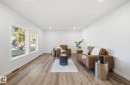 Living area featuring light vinyl plank floors, recessed lighting, fresh paint and new windows. - 13507 124 Avenue, Edmonton, AB  - Indoor Photo Showing Living Room 