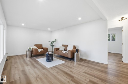 Living area featuring light vinyl plank floors, recessed lighting, fresh paint and new windows. - 13507 124 Avenue, Edmonton, AB - Indoor Photo Showing Other Room