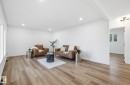 Living area featuring light vinyl plank floors, recessed lighting, fresh paint and new windows. - 13507 124 Avenue, Edmonton, AB  - Indoor Photo Showing Other Room 