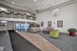 Building lobby featuring a high ceiling and recessed lighting - 