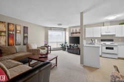 Living area with a textured ceiling and an AC wall unit - 