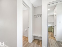 Mudroom with light wood-style floors - 