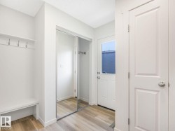 Mudroom with light wood-type flooring and baseboards - 