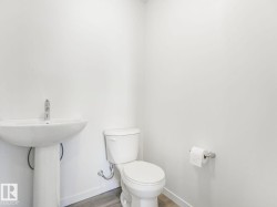 Half bathroom featuring wood finished floors and baseboards - 