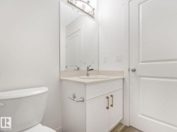 Half bathroom featuring vanity and light wood finished floors - 